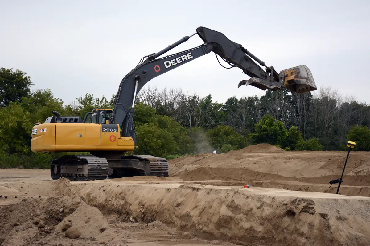 Countryside excavator excavating on job site
